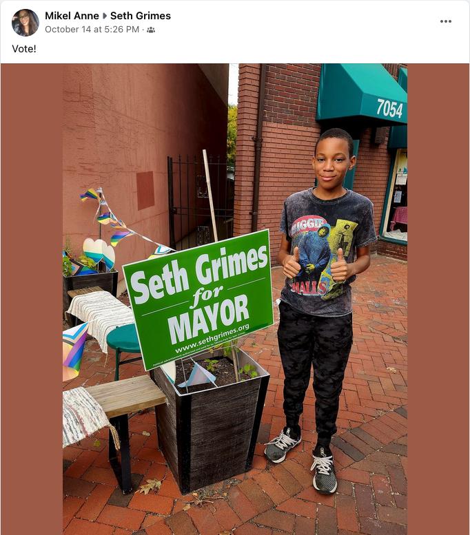 Kai with a Seth Grimes for Mayor sign -- and Mikel Ann says Vote!