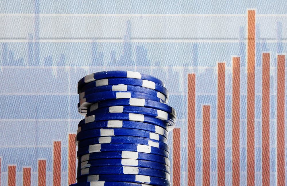 Stack of chips in front of a graph Stack of chips in front of a graph