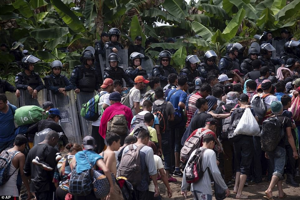 The second group back at the Guatemalan frontier has been more unruly than the first that crossed. Guatemala's Interior Ministry said Guatemalan police officers were injured when the migrant group broke through border barriers on Guatemala's side of the bridge